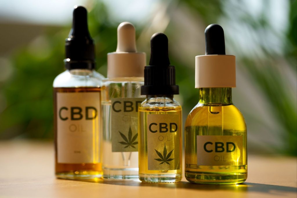 Assorted CBD oil bottles and products displayed at a tobacco shop Houston, featuring natural ingredients for wellness.
