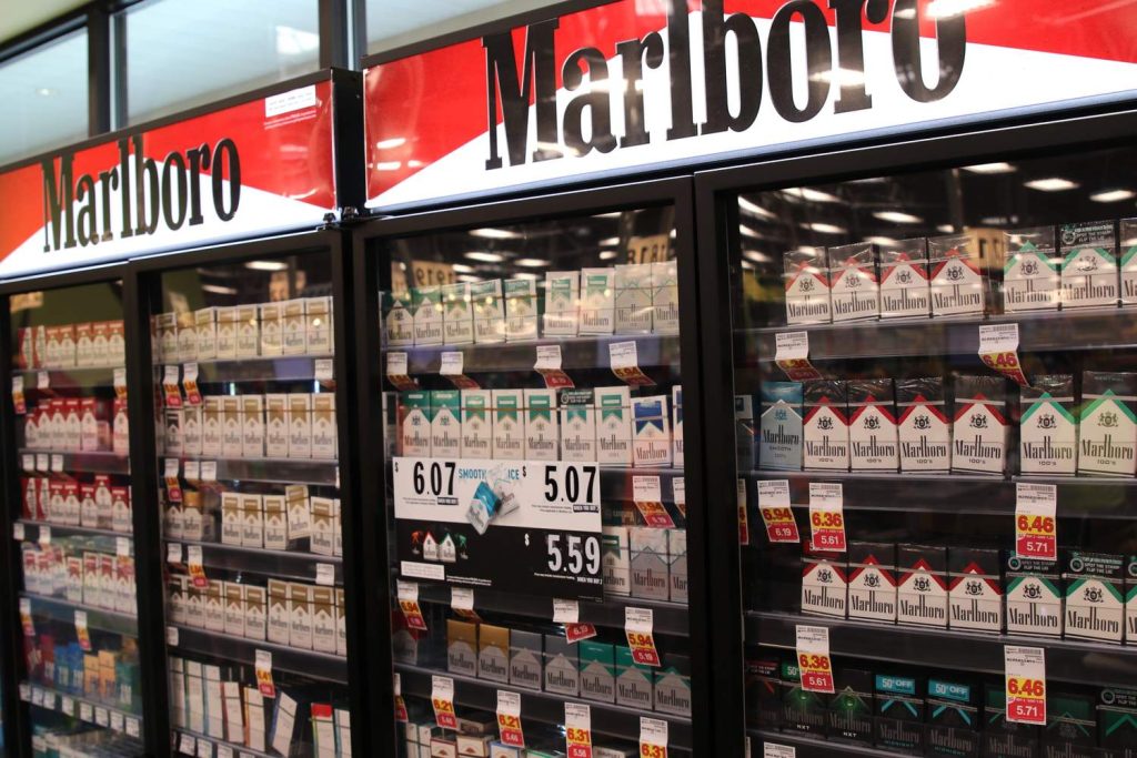 Well-stocked cigarette shop Houston display with various Marlboro packs and prices, offering a wide selection for smokers.
