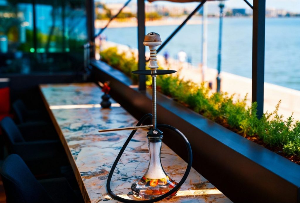 Elegant hookah on marble table with stunning waterfront view at premium hookah shop Houston.