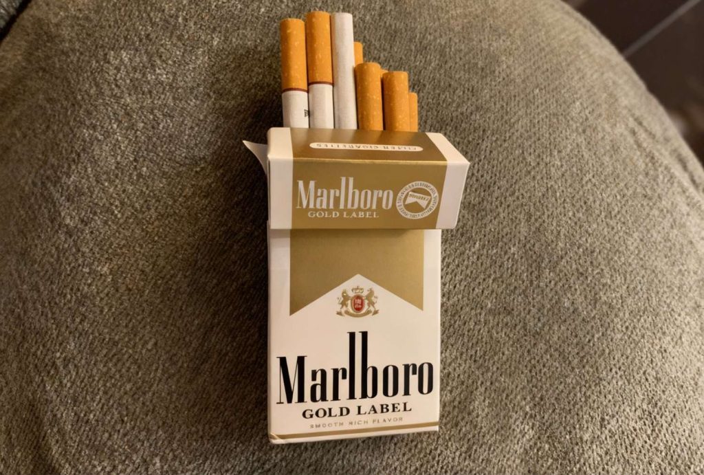 Marlboro Gold Label pack with cigarettes sticking out, premium selection at cigarette shop Houston.