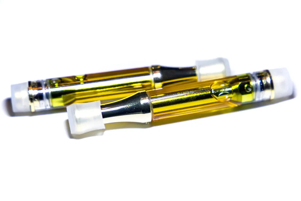 Two gold distillate oil vape cartridges, a popular choice from premium herbal vaporizers Houston shops.